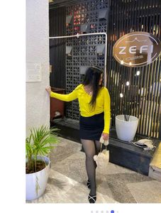 yellow top with black skirt