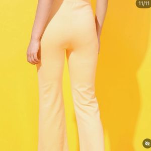 Yellow stretchable flared cotton trousers.