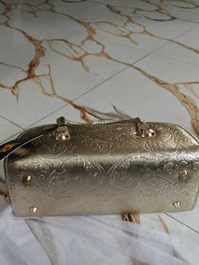 Elegant Gold Clutch with Gemstone Accent