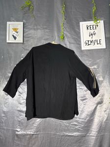 Chic Black Top with Embellished Sleeves