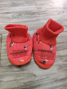 Bundle of baby clothes, beanie, shoes.