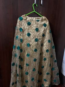green blouse with golden skirt and shawl