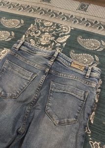 Distressed Blue Denim Jeans