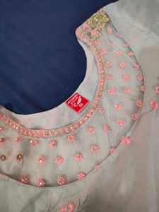 Embroidered organza kurti with net yoke.