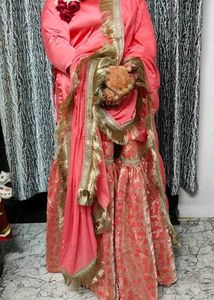 Stunning Coral Lehenga Choli with Gold Embellishme