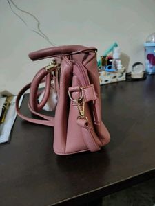 Stylish Pink Textured Handbag with Charm