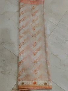 2 organza sarees one orange and another is pink on