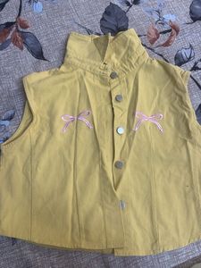 Yellow sleeveless top with bow details