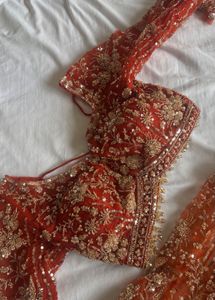 Stunning Orange Embellished Lehenga Choli