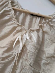 Cream ruched tie-front sleeveless top