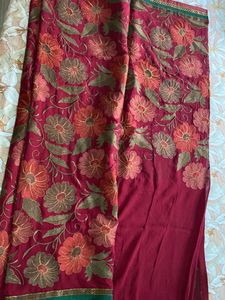 Maroon coloured Embroidered saree With Stitched blouse