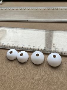 Four White Spherical Beads with Holes