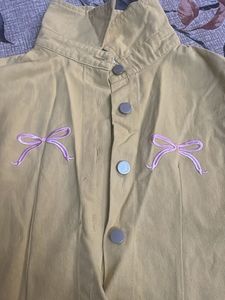 Yellow sleeveless top with bow details