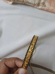 Elegant Gold Bangle with Black Stones