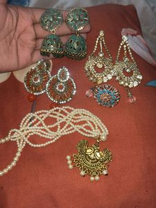 stylish indian earing with a pearl choker and ring