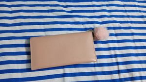 Chic Pink Studded Clutch with Pom Po
