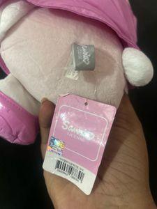 Sanrio My Melody plush toy wearing a glossy pink