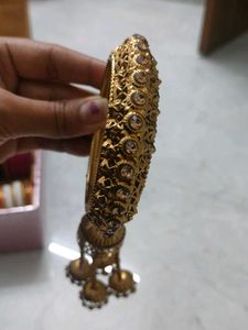 Elegant Gold Tone Bangle with Tassel