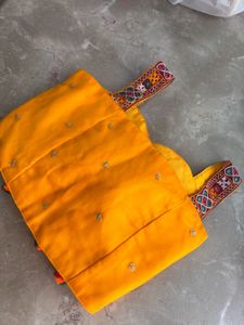 navarti yellow colpur blouse witha border on it