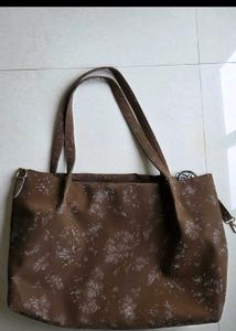 Cute shoulder bag with self color floral print.