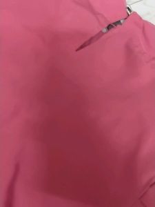 Chic Pink Smocked Top with Brooch Detail