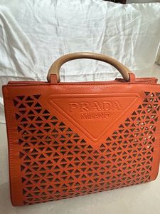 An orange Prada Bag