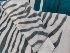 White Velvet Sweater With Black Stripes On It