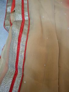 Vibrant Orange Saree with Pearl Embellishments