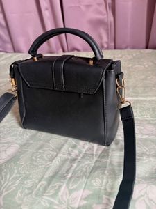 Chic Black Handbag with Gold Accents