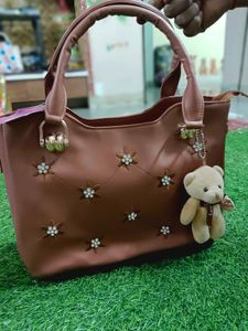 Elegant Brown Handbag with Floral Accents