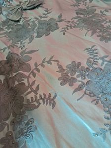 Soft pastel blue dress with elegant floral detaili