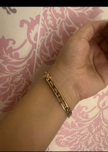 Elegant Gold Tone Watch with Charm