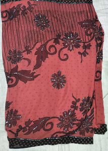 Elegant Coral Saree with Black Floral Print