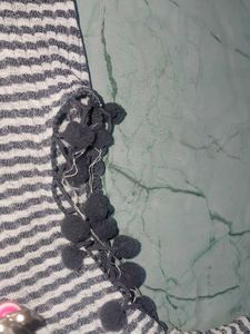 stripped knitted top with pom-poms on sleeve
