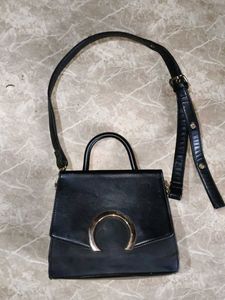 Chic Black Handbag with Gold Accent