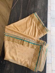 cream colour saree with peacock blue blouse