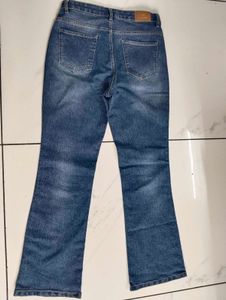 Flared Blue Jeans with Button Detail