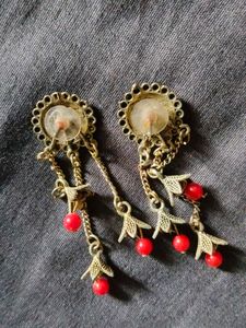 women earrings with red beads hanging