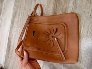 Tan crossbody bag with flower detail