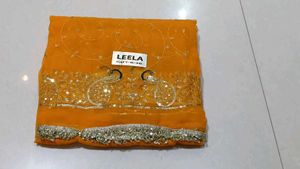 Elegant Orange Saree with Peacock Embellishments