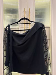 Chic Black Top with Polka Dot Sleeves