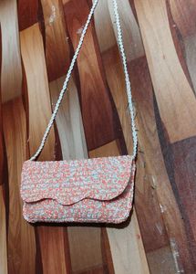 beautiful stylish orange and white colour sling ba