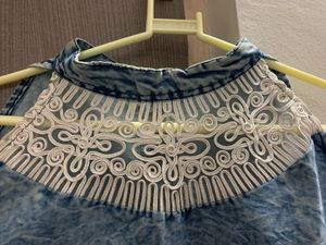Sleeveless top with white lace detail on neckline