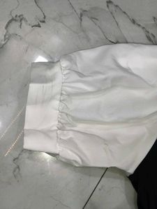 A great black top with white sleeves and collar.