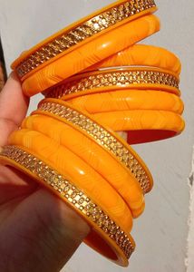 Vibrant Orange Bangle Set with Golden Embellishmen