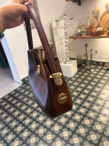 brown sling bag with belt