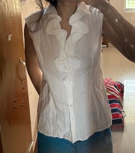 Elegant White Sleeveless Ruffle Blouse