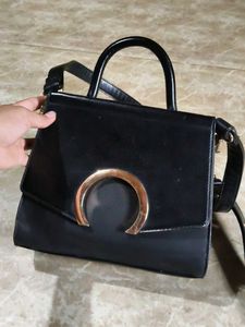 Chic Black Handbag with Gold Accent