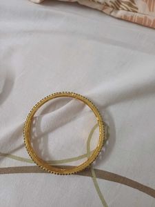Elegant Gold Bangle with Black Stones