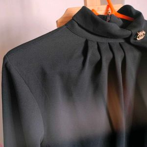 Elegant Black Mock Neck Top with Brooch